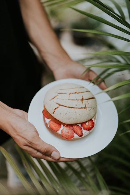Delicious concha bread filled with strawberries and cream, perfect for dessert lovers.