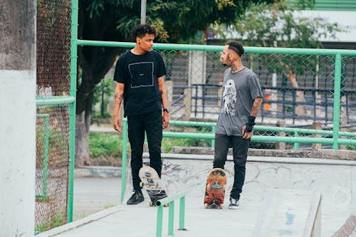 Men Standing at the Skate Park while Having Conversation