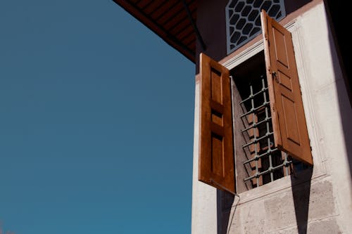 Wooden Shutters on Window with Bars