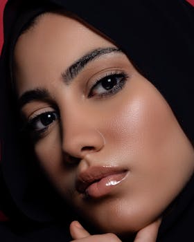 Close-up portrait capturing the elegant beauty of a woman in a hijab. Perfect lighting highlights her features.