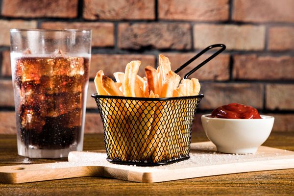 Basket of fries with a cold drink, photo by Franciano Puhales on Pexels