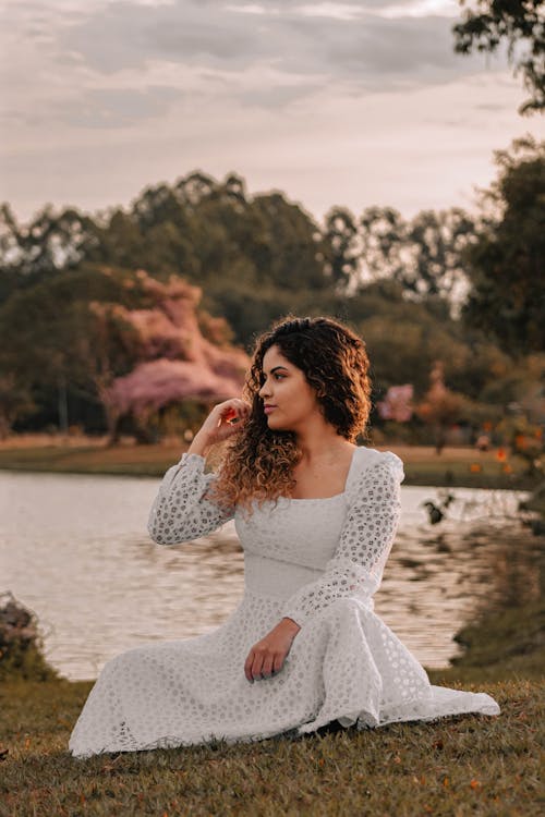 Curly Haired Woman Wearing White Long Sleeve Dress 