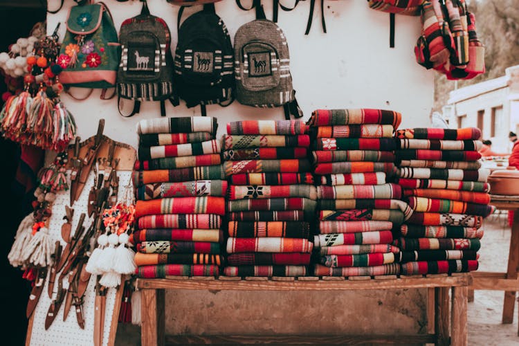 Stacks Of Folded Textiles Displayed During The Regional Crafts Fair
