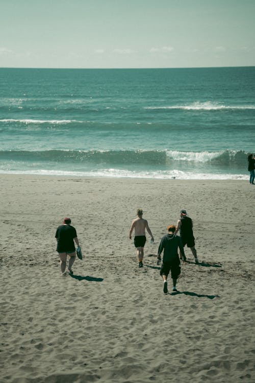 People Walking on Beach Sand