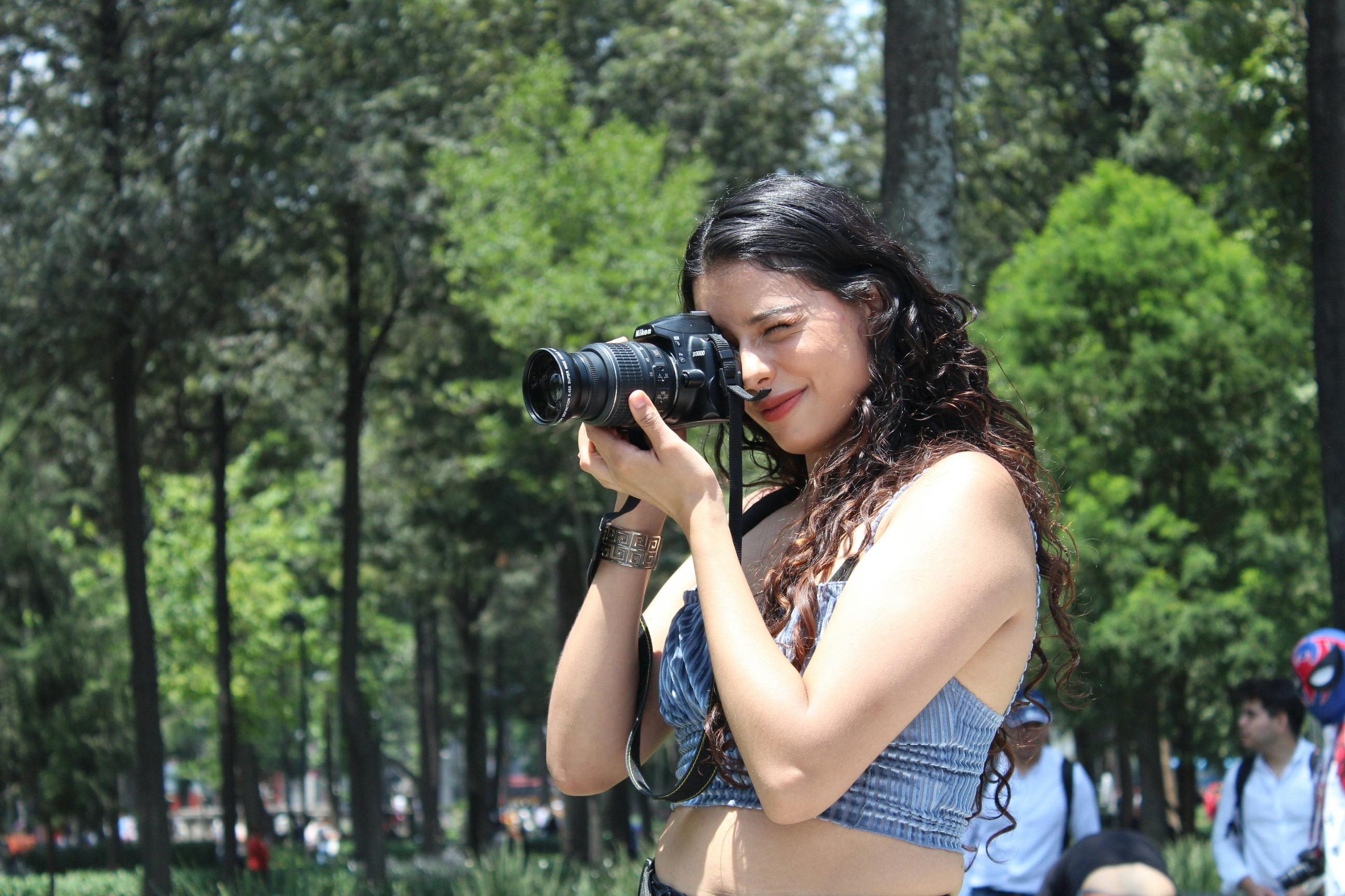 woman photographing in a park