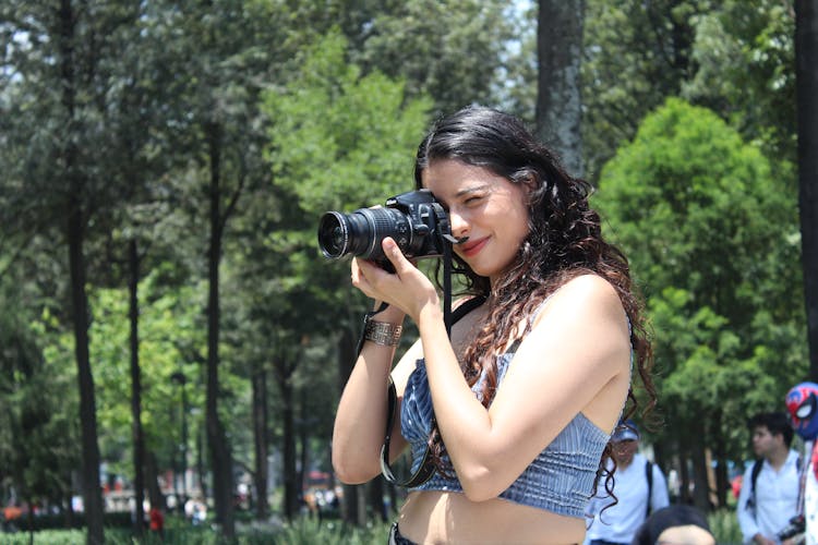 Woman Photographing In A Park