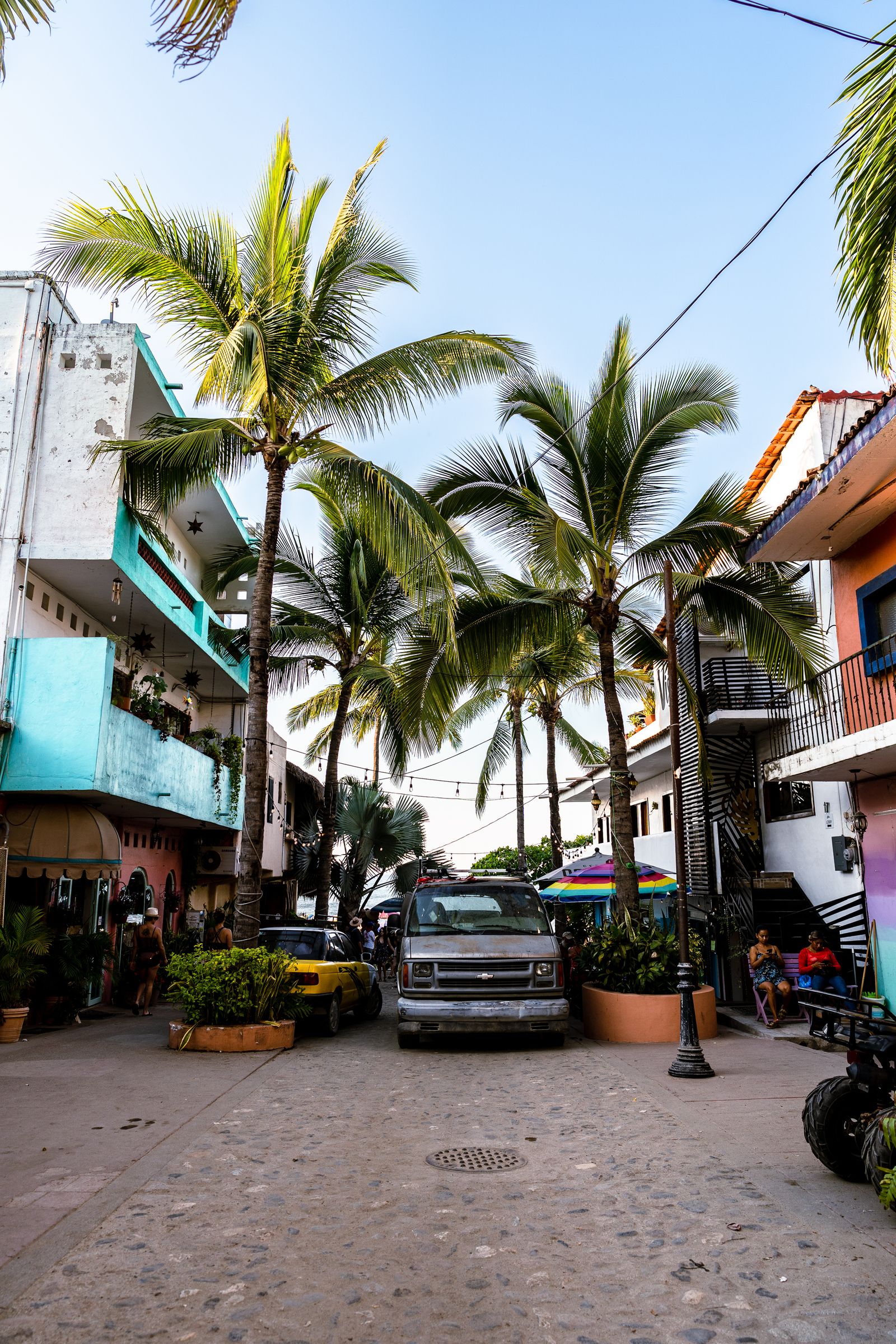 Palm-lined street with colorful buildings in Sayulita