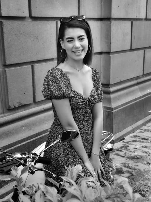 Free Woman in Black and White Leopard Print Dress Standing Beside Bicycle Stock Photo