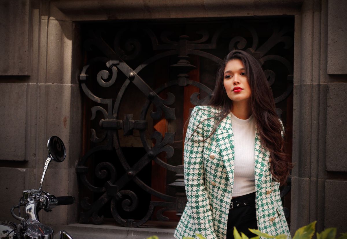 Latina woman styling a rebozo-inspired shawl layer over an outfit