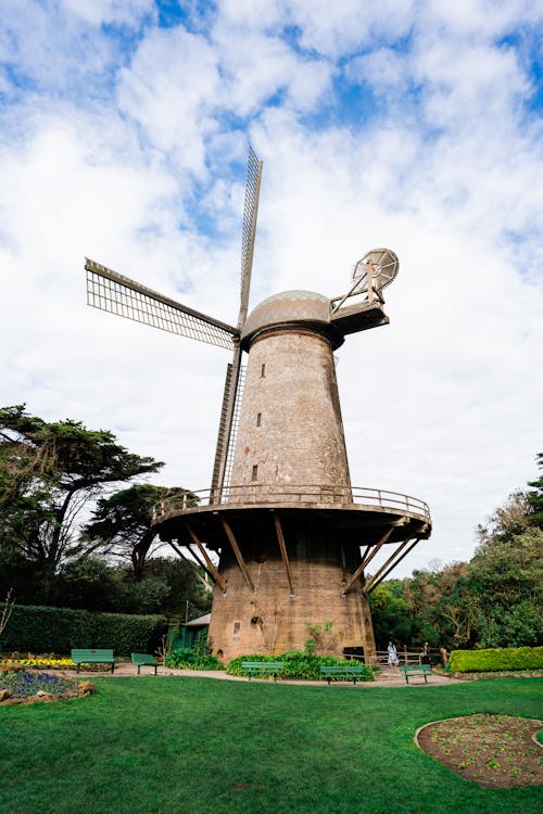 Brown and White Windmill Under White Clouds