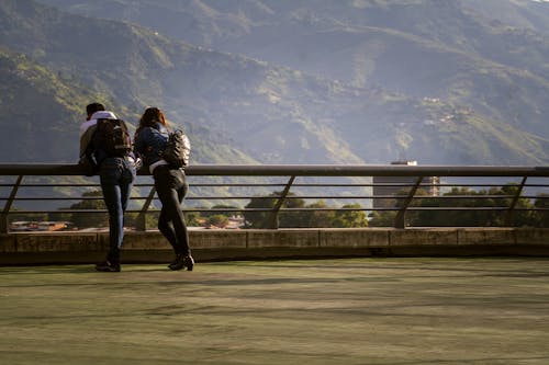 Couple Standing Beside Metal Railing