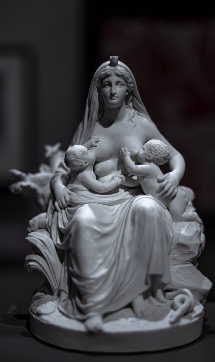 A Woman Statue Breastfeeding A Pair Of Babies