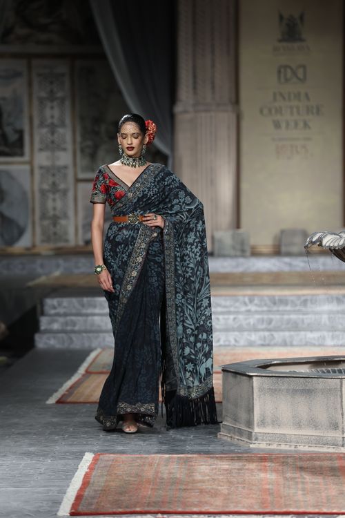 Free Model gracefully walking the runway wearing a beautiful saree at a fashion show. Stock Photo