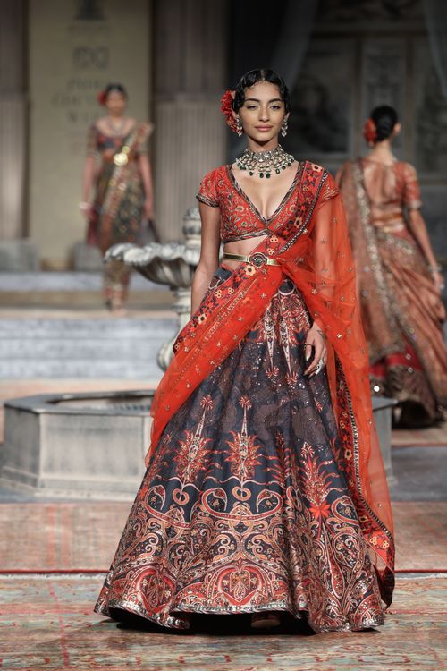 Free Elegant model showcasing traditional attire on fashion runway. Stock Photo