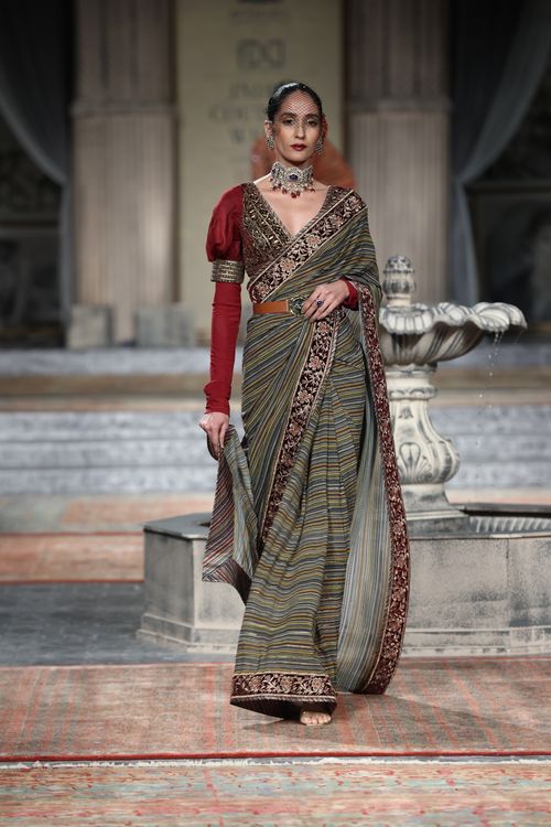 Free Model posing elegantly in a traditional saree at a fashion show. Stock Photo