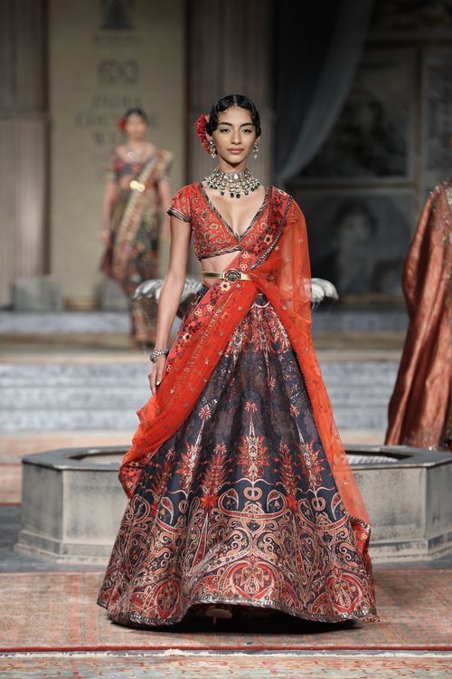 Free Model showcasing traditional attire on a fashion runway. Stock Photo
