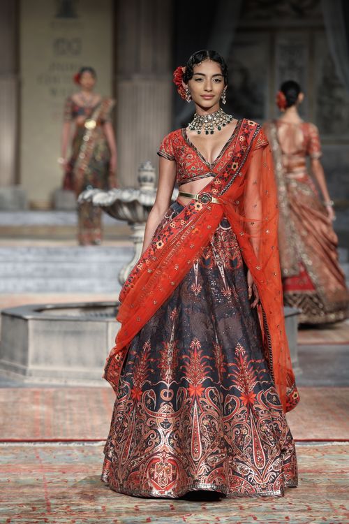 Free Beautiful fashion model showcasing traditional Indian dress on runway. Stock Photo