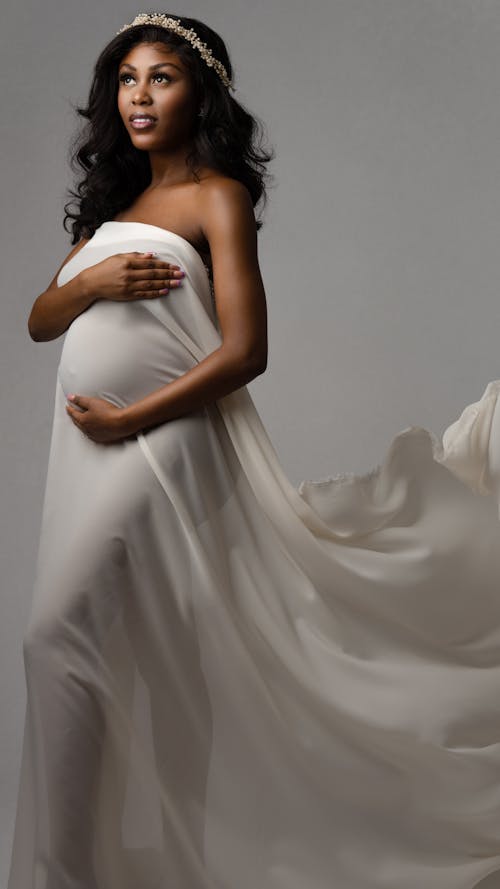 W Woman Wrapped in White Textile in the Studio