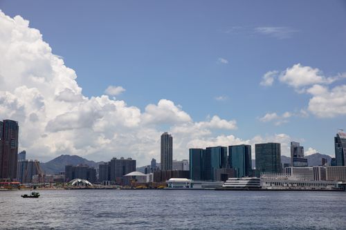 Free Beautiful Hong Kong skyline featuring Victoria Harbour under a clear blue sky. Stock Photo