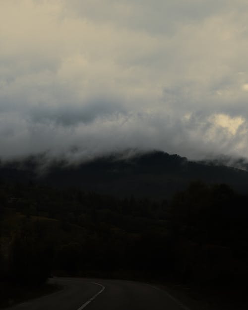 Clouds Over the Countryside Road Near the Mountain