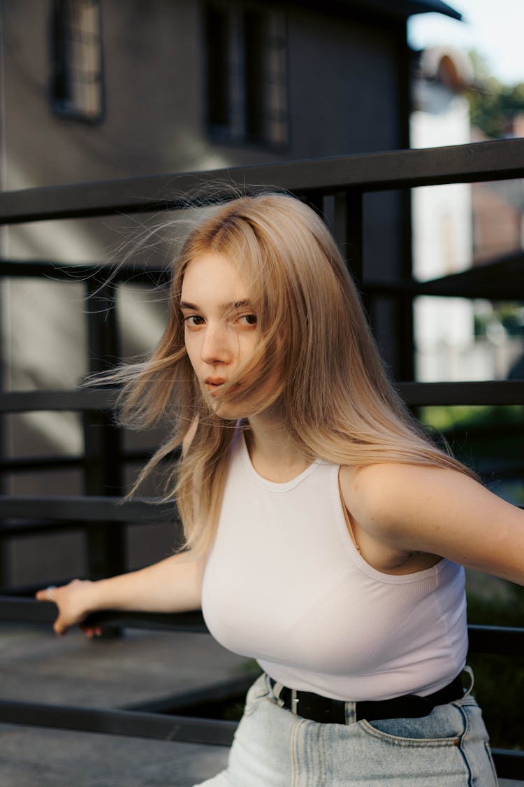 Woman Holding Barriers And Posing