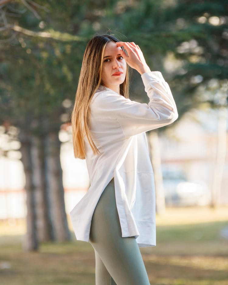 Standing Young Woman Fixing Hair