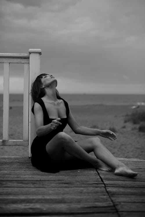 Portrait of a Woman Sitting on a Pier