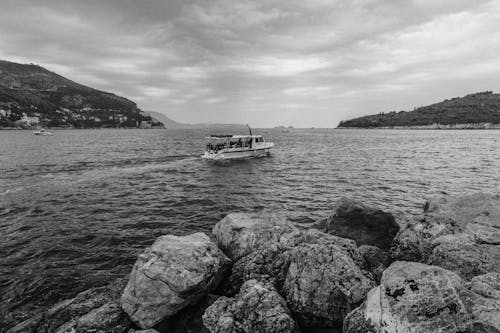 Grayscale Photography of Boat on Sea