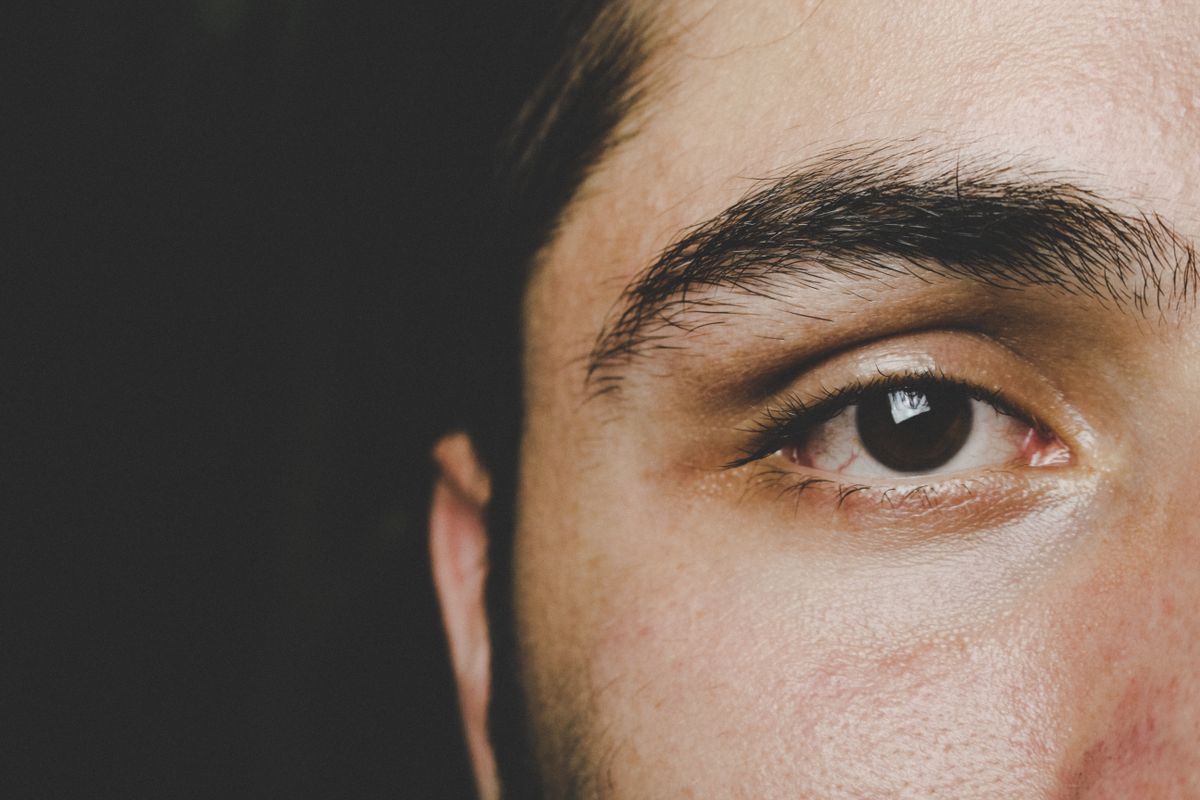 Detailed close-up of a man's eye and eyebrow