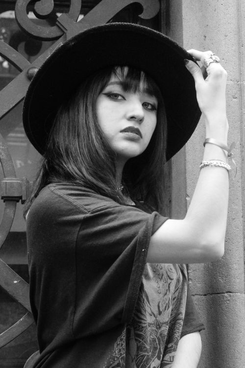 Free Black and white portrait of a stylish woman posing with a hat. Stock Photo