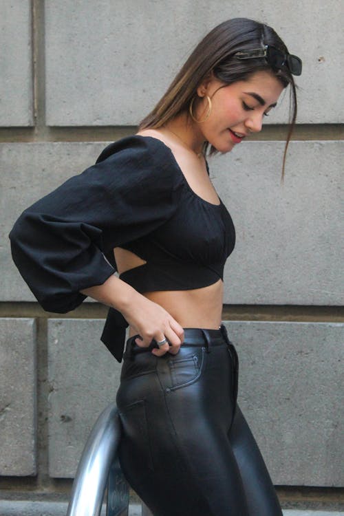 A Woman Wearing Crop Top and Leather Pants 