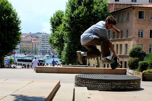 Teenage Boy Doing Skateboard Tricks on Park Steps