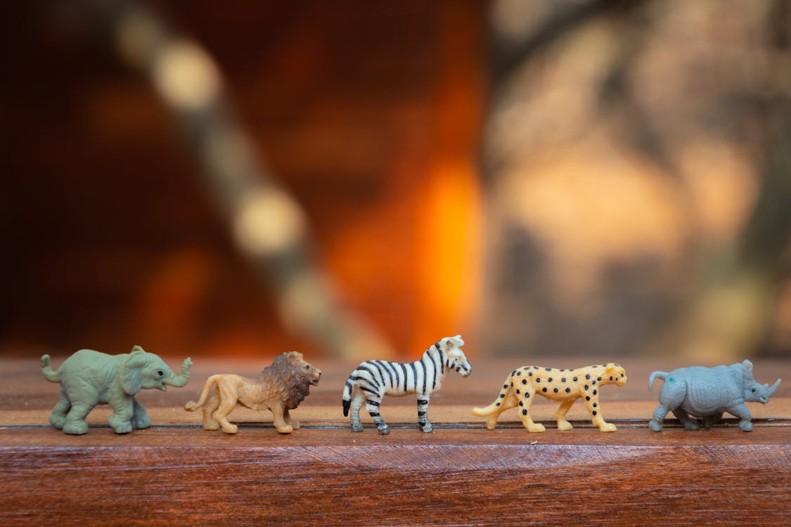 Free Plastic Animal Toys on Wooden Surface Stock Photo
