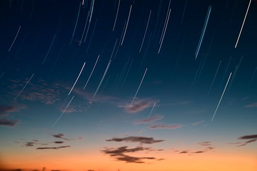 Capturing a serene star trail over a colorful sunset sky, enhancing twilight beauty.