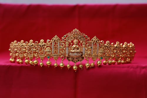 A Gold Crown on Red Surface in Close-up Shot
