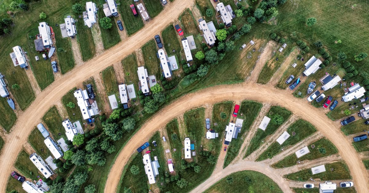 Aerial shot of trailer homes arranged in a curved layout in Nelson, Wisconsin. Captures rural landscape.