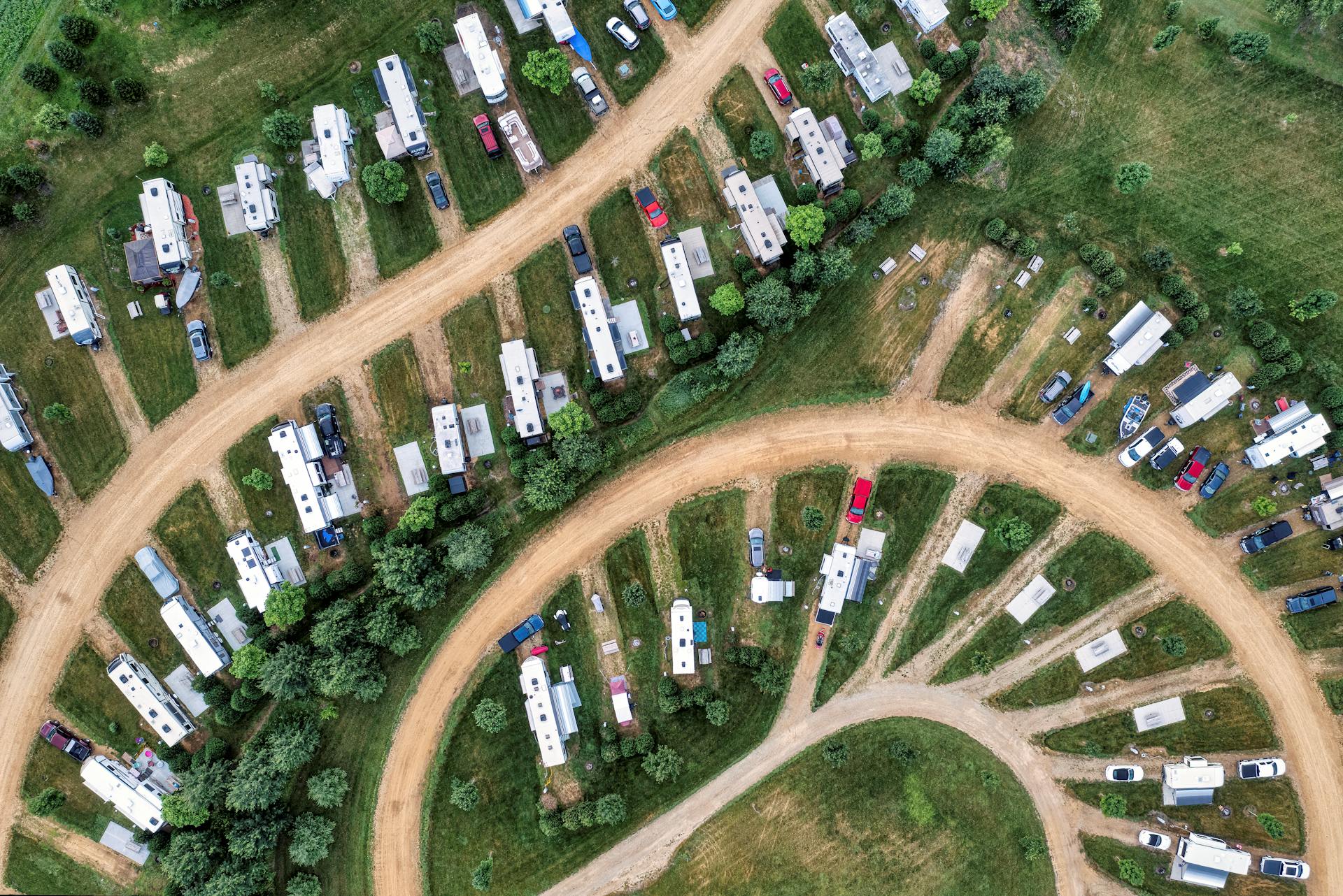 Aerial shot of trailer homes arranged in a curved layout in Nelson, Wisconsin. Captures rural landscape.