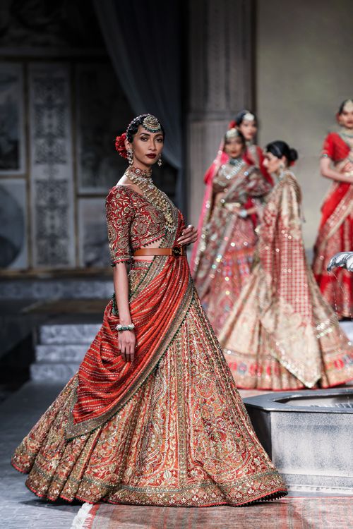 Free Models showcase intricate traditional Indian outfits on a runway in New Delhi. Stock Photo