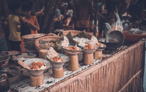 Free Vibrant street food market with various dishes displayed in unique bowls and plates. Stock Photo