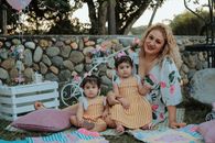A joyful family picnic in La Dorada, Colombia featuring a mother and her two children outdoors.