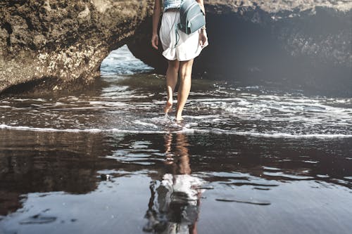 Woman Walking on Seashore