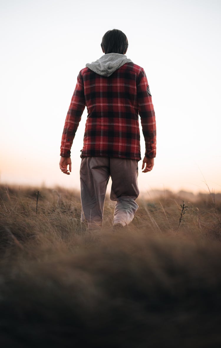 Back Of A Man Walking Up A Hill