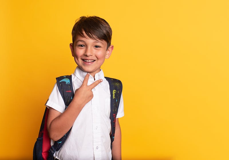 Smiling boy with backpack ready for school