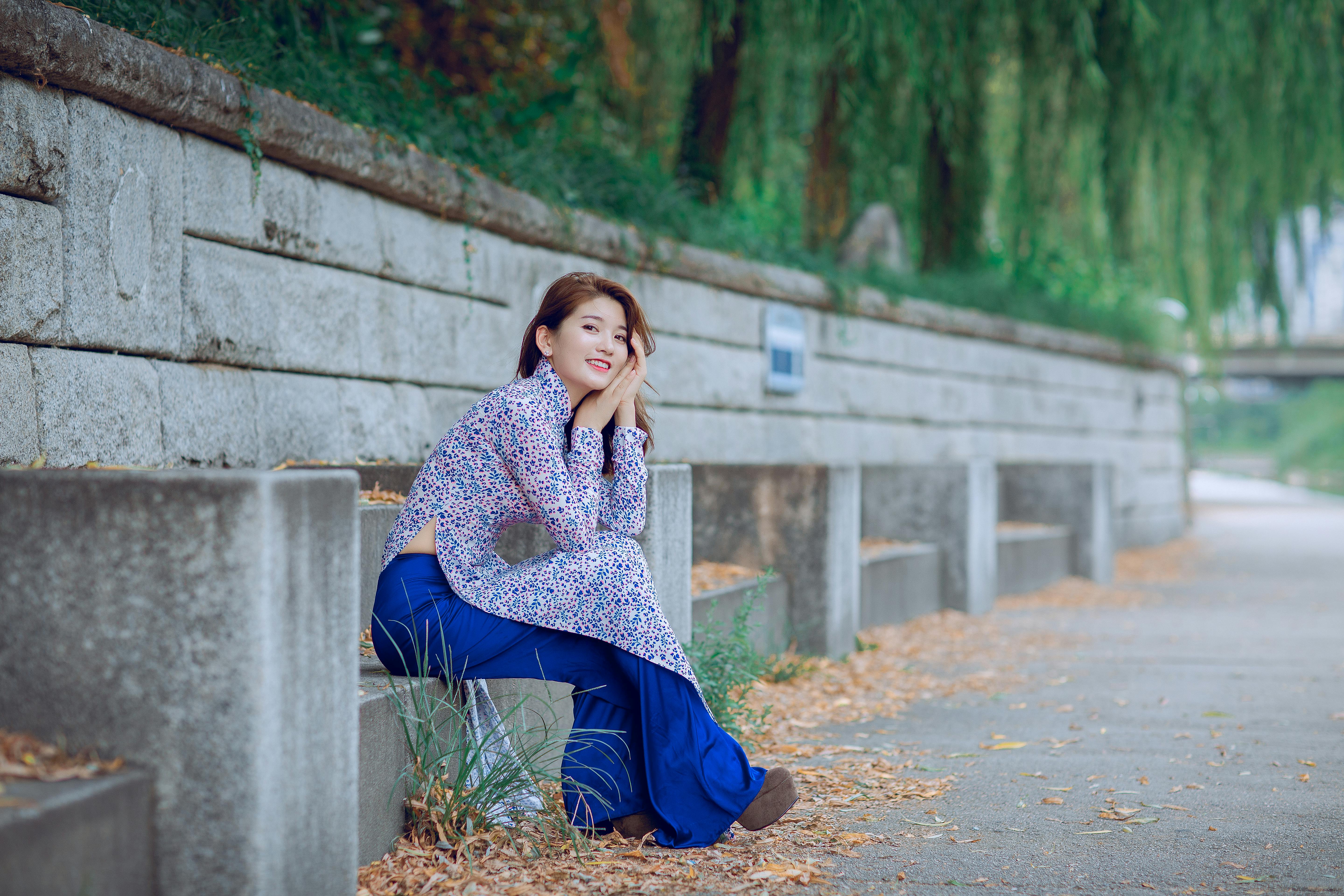 Woman Sitting On Grey Concrete Chair