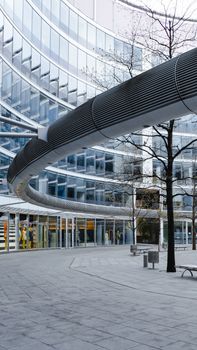 Contemporary building design featuring curved facades and glass surfaces in Warsaw's urban landscape.
