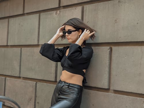 A Woman Wearing Crop Top and Leather Pants 