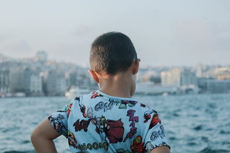 Back Of A Boy Looking At A River