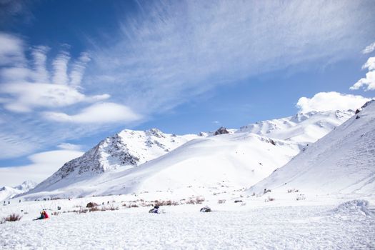 Scenic snow-covered Andes Mountains in Los Penitentes, Argentina, with a vibrant winter sky.