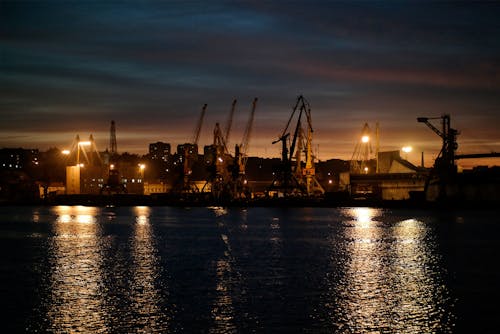 Cranes in a Harbor at Night 