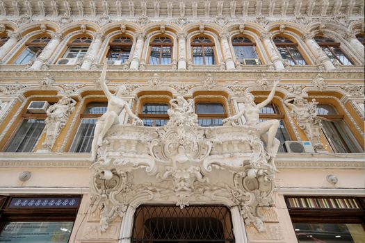 Intricate architectural facade with art nouveau sculptures at Odesa Passage, Ukraine.